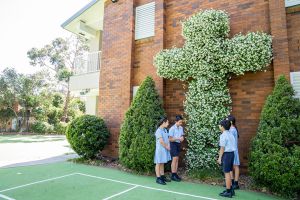 St Therese Mascot Catholic Primary School Religious Life Students in front of large flower cross